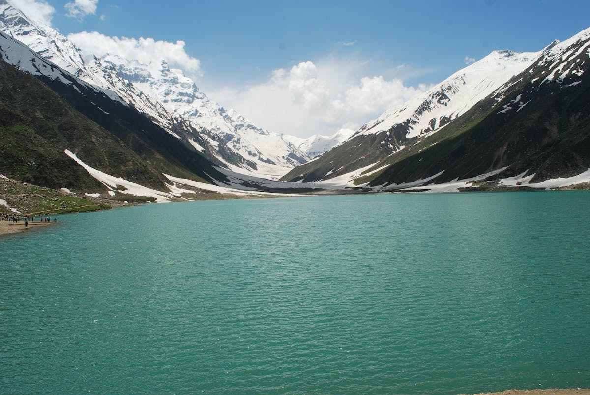 Saif-ul-Malook alpine lake with snow-capped mountains in Naran Kaghan, Pakistan